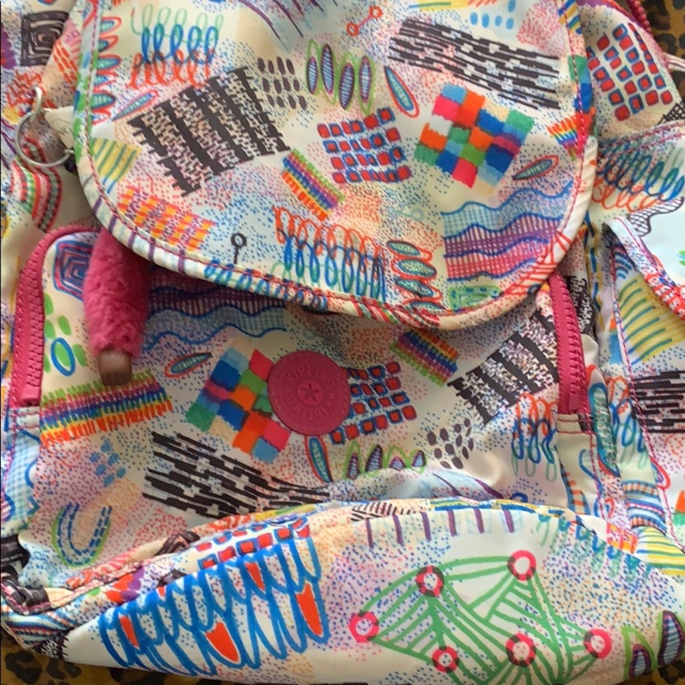 A multi- colored Kipling backpack